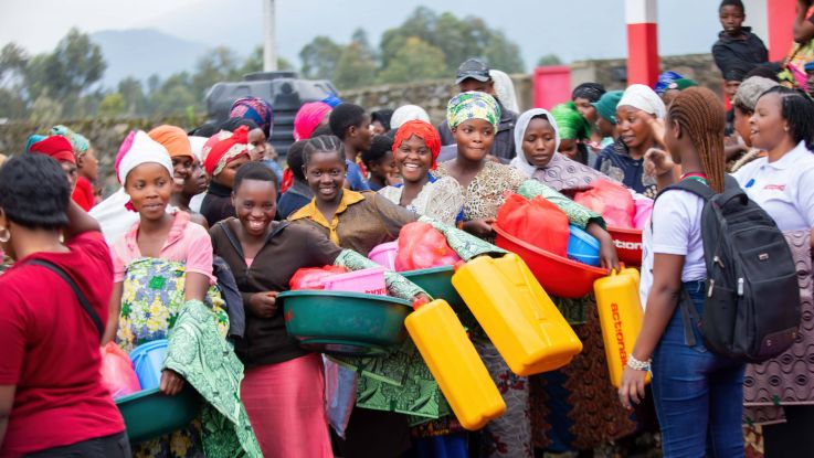 women collecting hygiene kits from other women leaders 