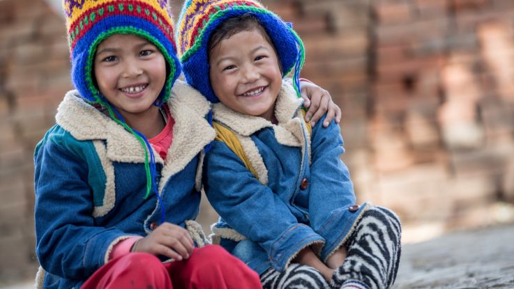 Kristina and Krishla, from Nepal, have received coats and hats from ActionAid