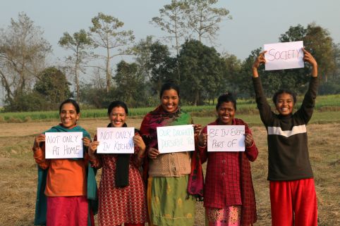 Girls and women in Nepal holding up signs