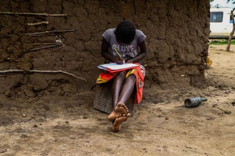 Girl writing in her copy book