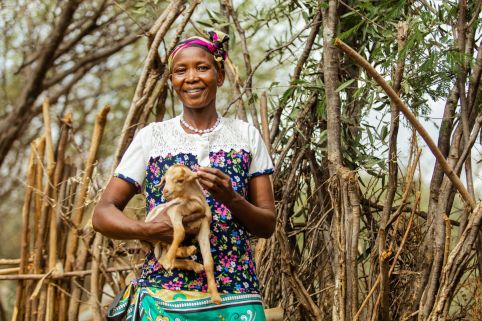 Woman holding a kid goat