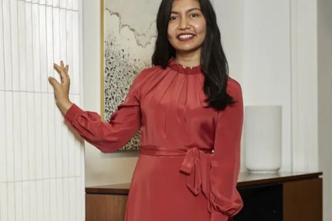 Ruby standing against a wall