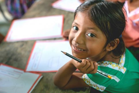 Blanca, a student excitedly draws a picture for her sponsor in the UK during ActionAid's annual child message collection in Guatemala